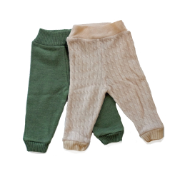 Front view of two pairs of long cashmere wool diaper cover pants, cream with chain knit and medium green